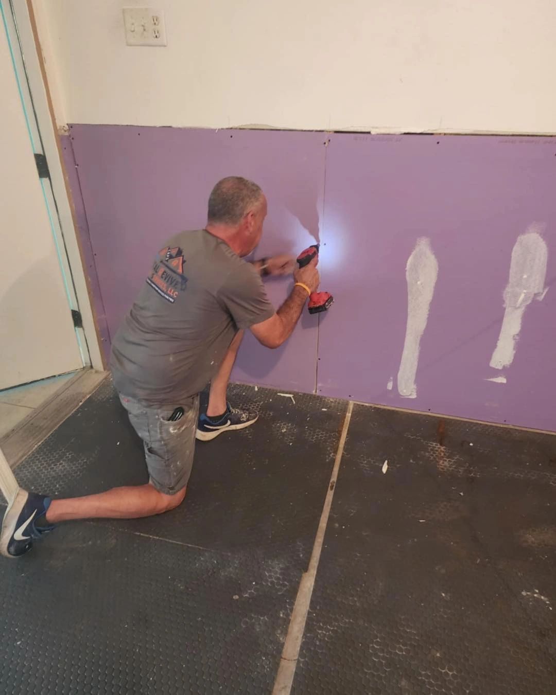 Drywall work in a Coastal Revive shirt