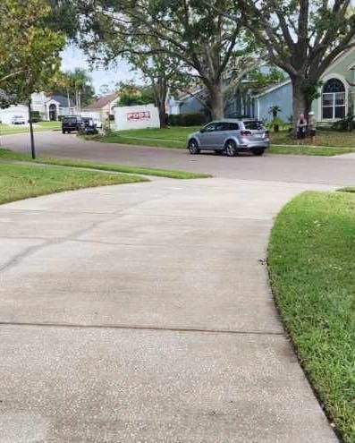 Clean concrete driveway on a suburban street