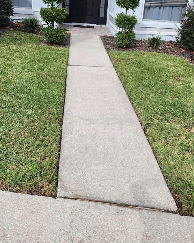 Clean concrete walkway after pressure washing